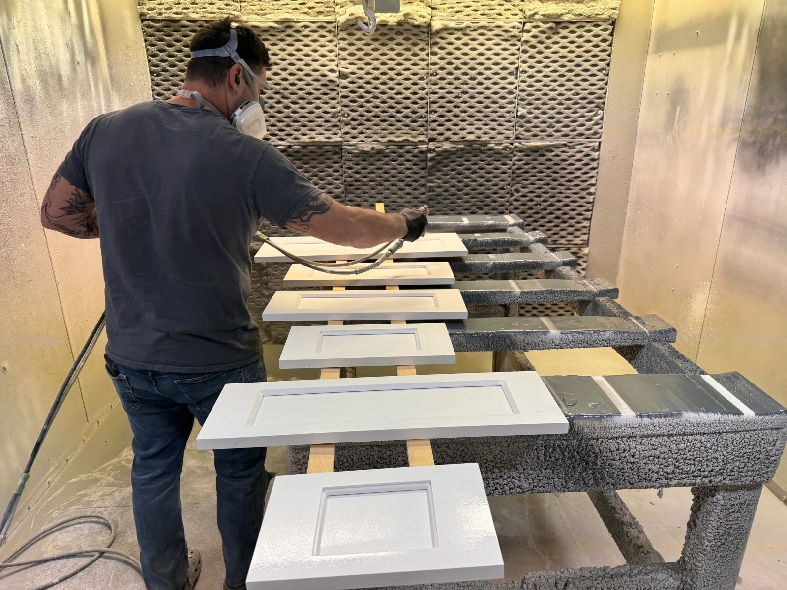 Spraying cabinet doors in the finish department